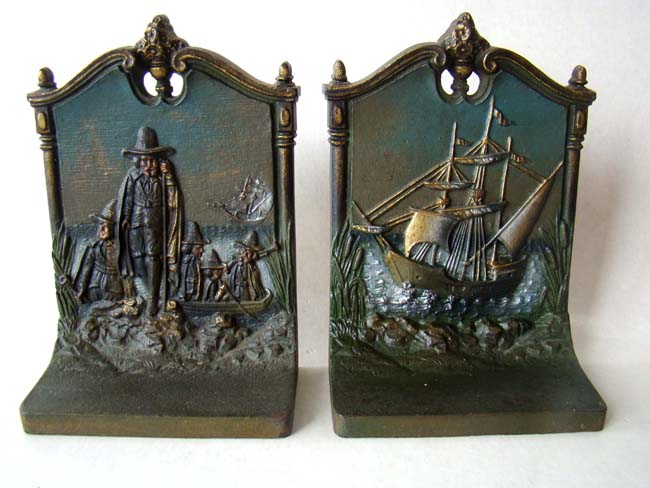 A pair of cast iron bookends circa 1930 by Bradley & Hubbard depicting the Mayflower and the Pilgrims landing at Plymouth.